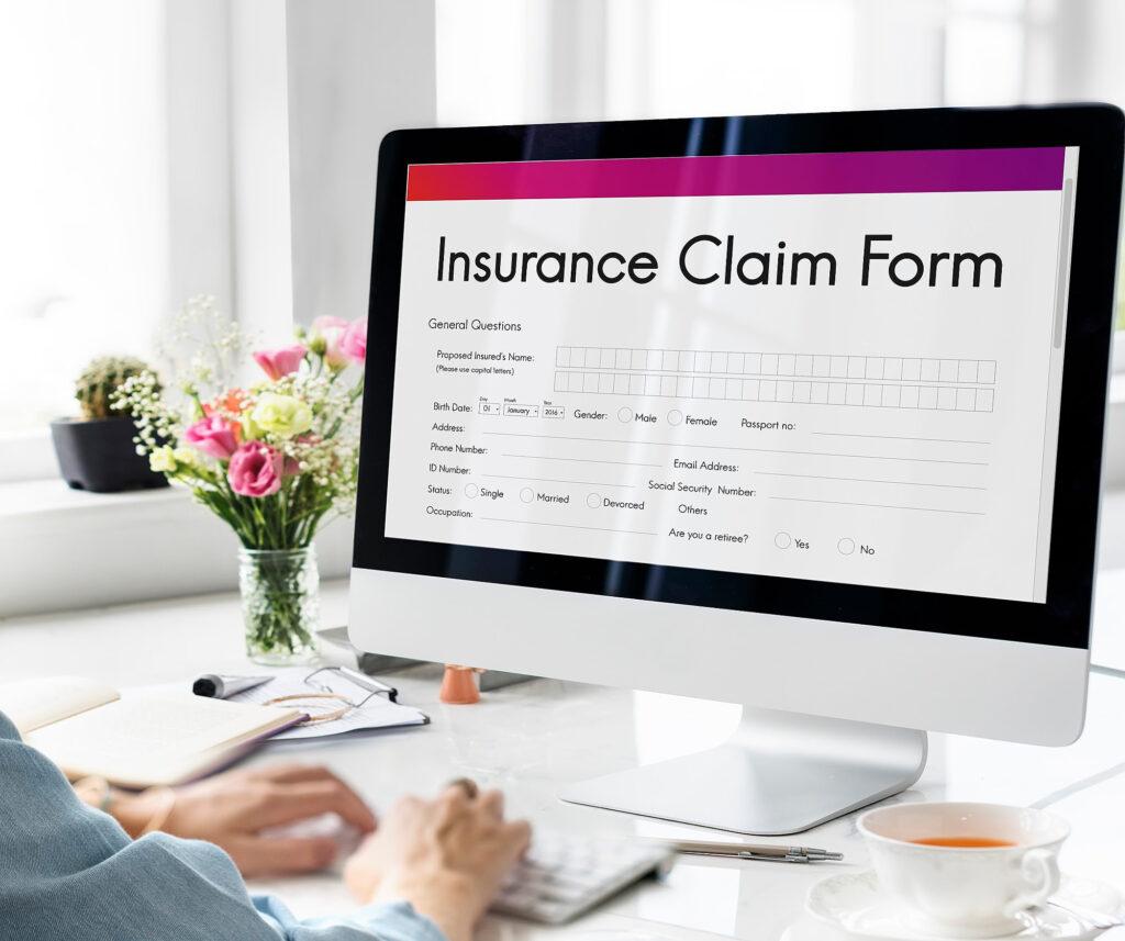 AI in Insure tech: a lady filling an insurance claim form.